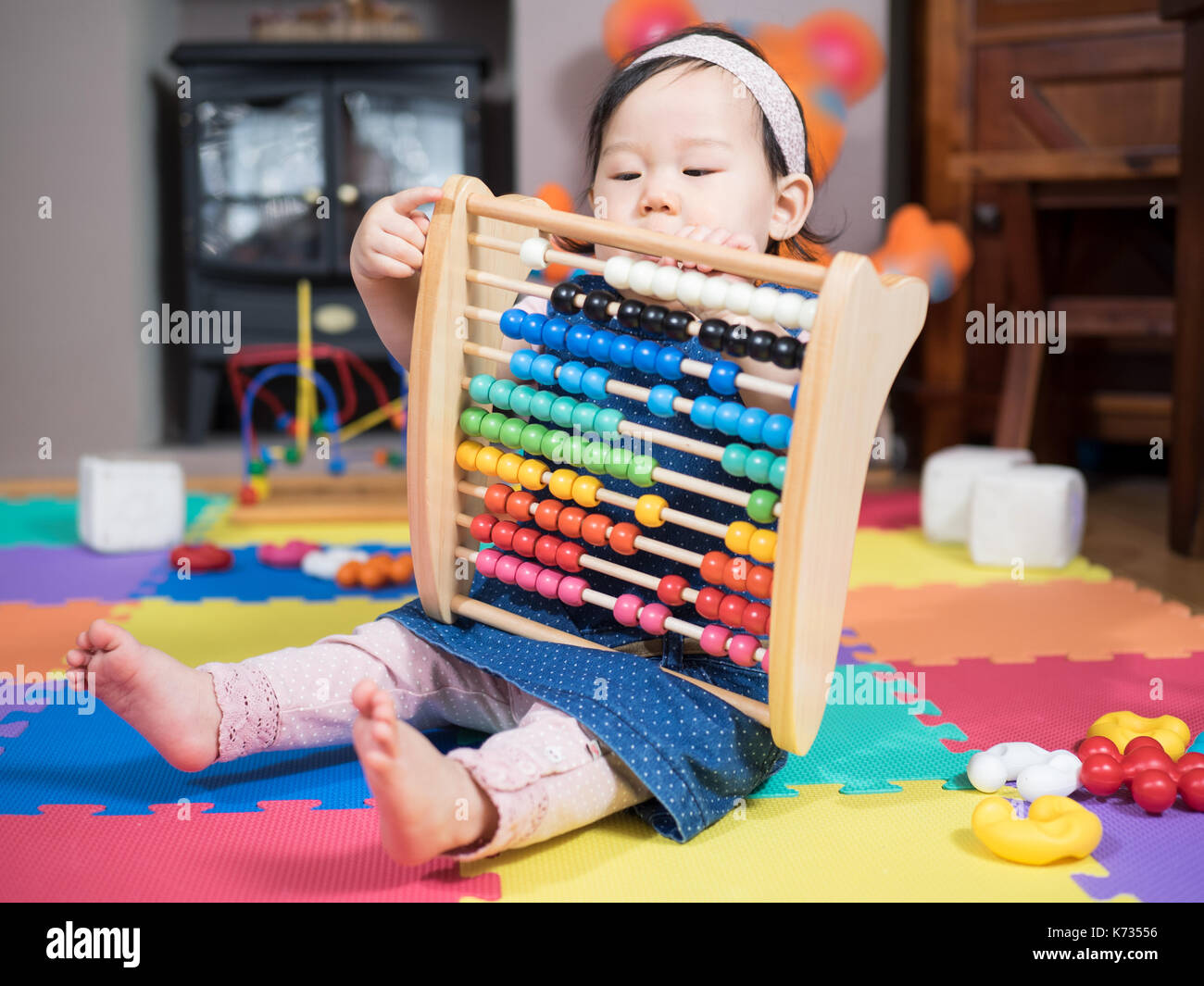 Cute baby girl playing toys at home Stock Photo - Alamy