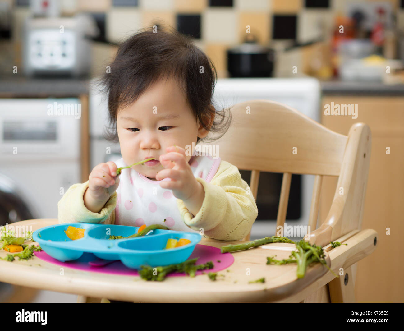 baby eating vegetable at home Stock Photo - Alamy