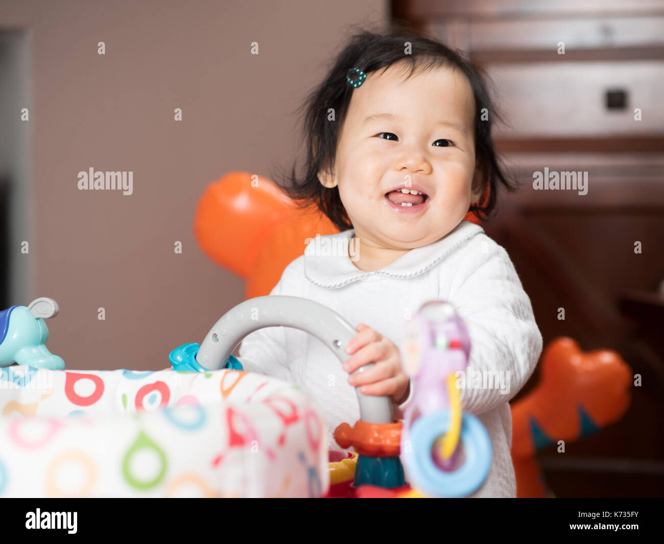 baby girl playing toy at home Stock Photo - Alamy