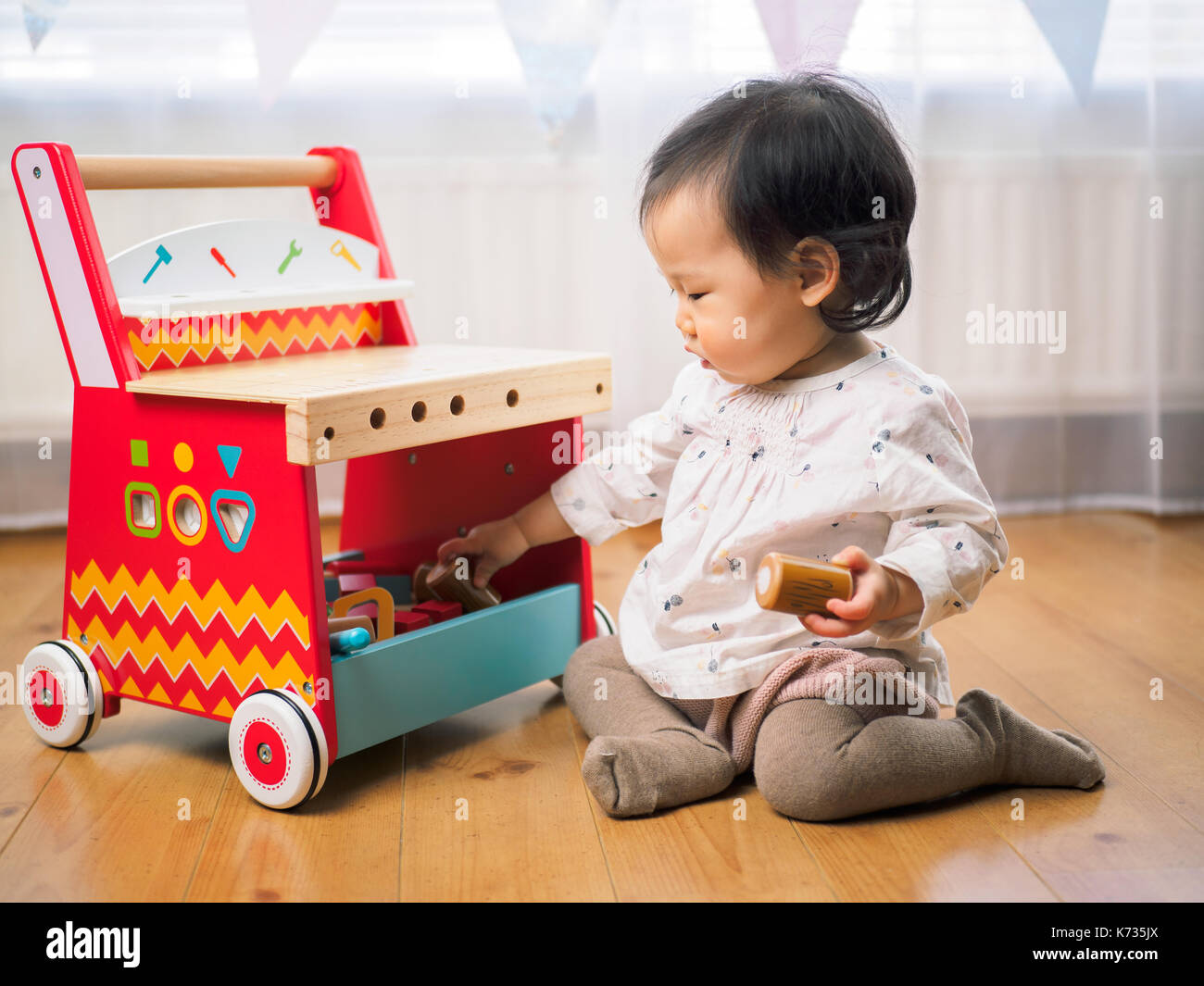 cute baby girl play toy at home Stock Photo - Alamy