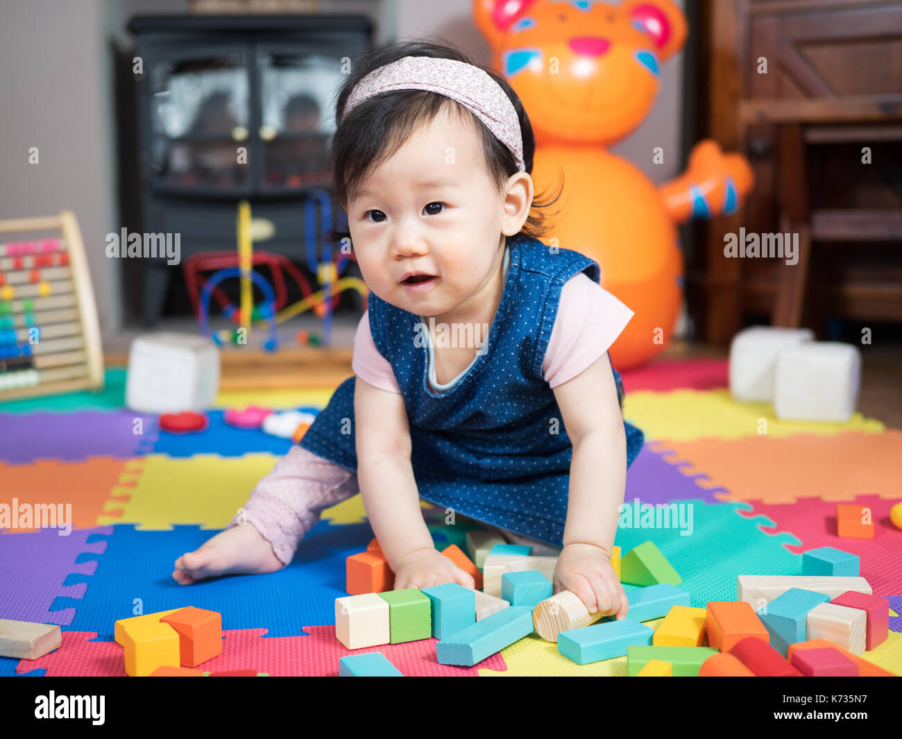 baby girl playing toy at home Stock Photo - Alamy