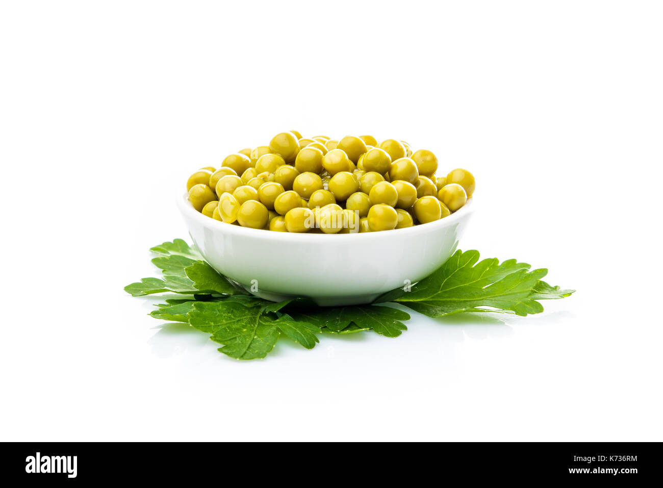 green peas in a bowl isolated, white background Stock Photo - Alamy