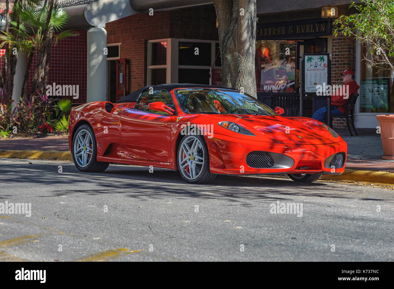 Red Ferrari F430 Spider sports car parked on the street in Hyde Park, Tampa, Florida, United States. The Ferrari is considered a super car. Stock Photo