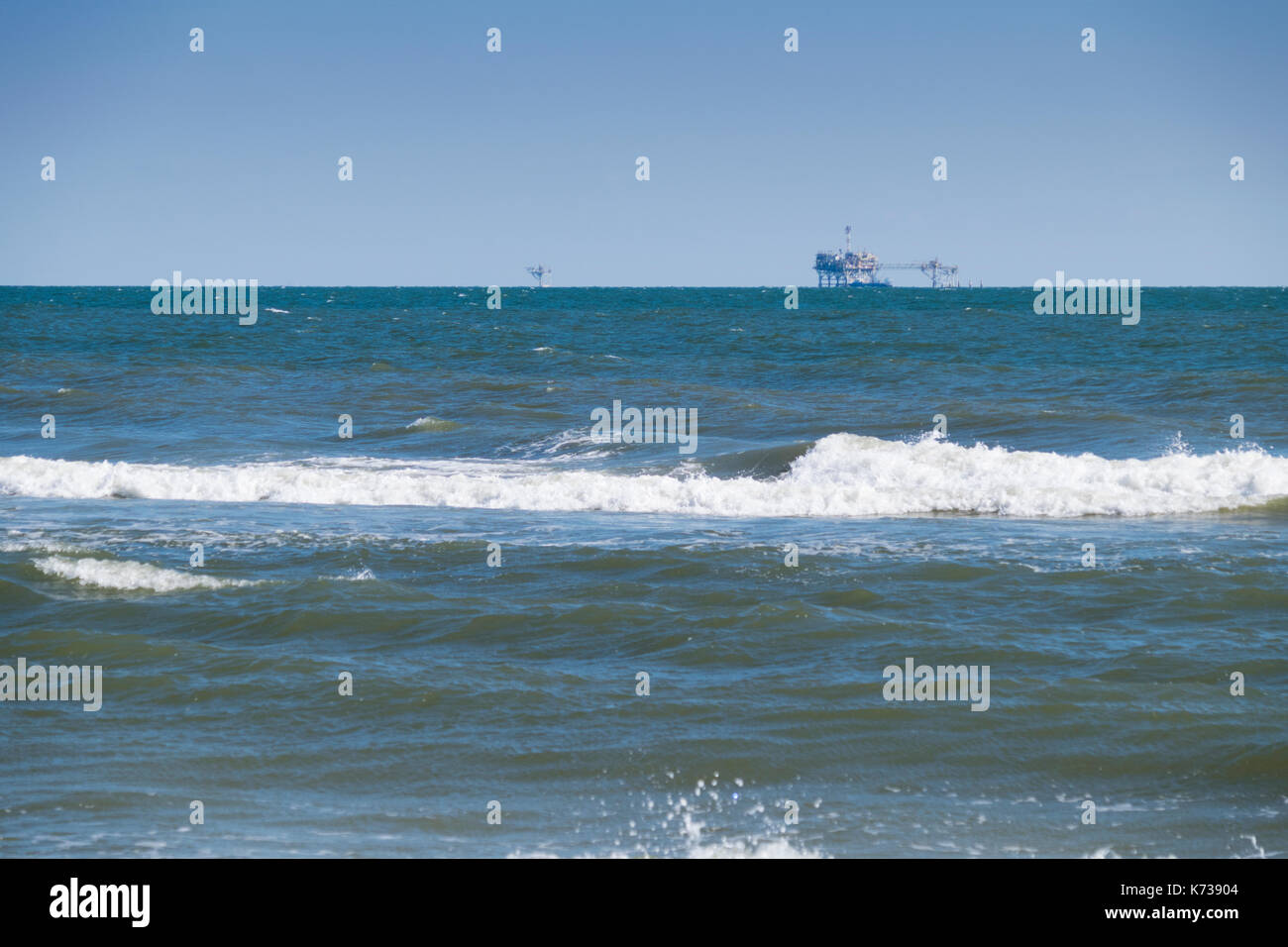 Natural gas platforms sit in the Gulf of Mexico offshore from Gulf Shores, Alabama. Stock Photo