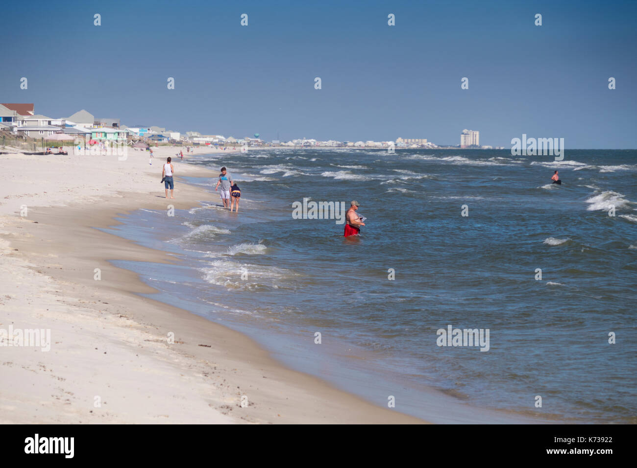 People playing on the beach and in the surf near Gulf Shores, Alabama