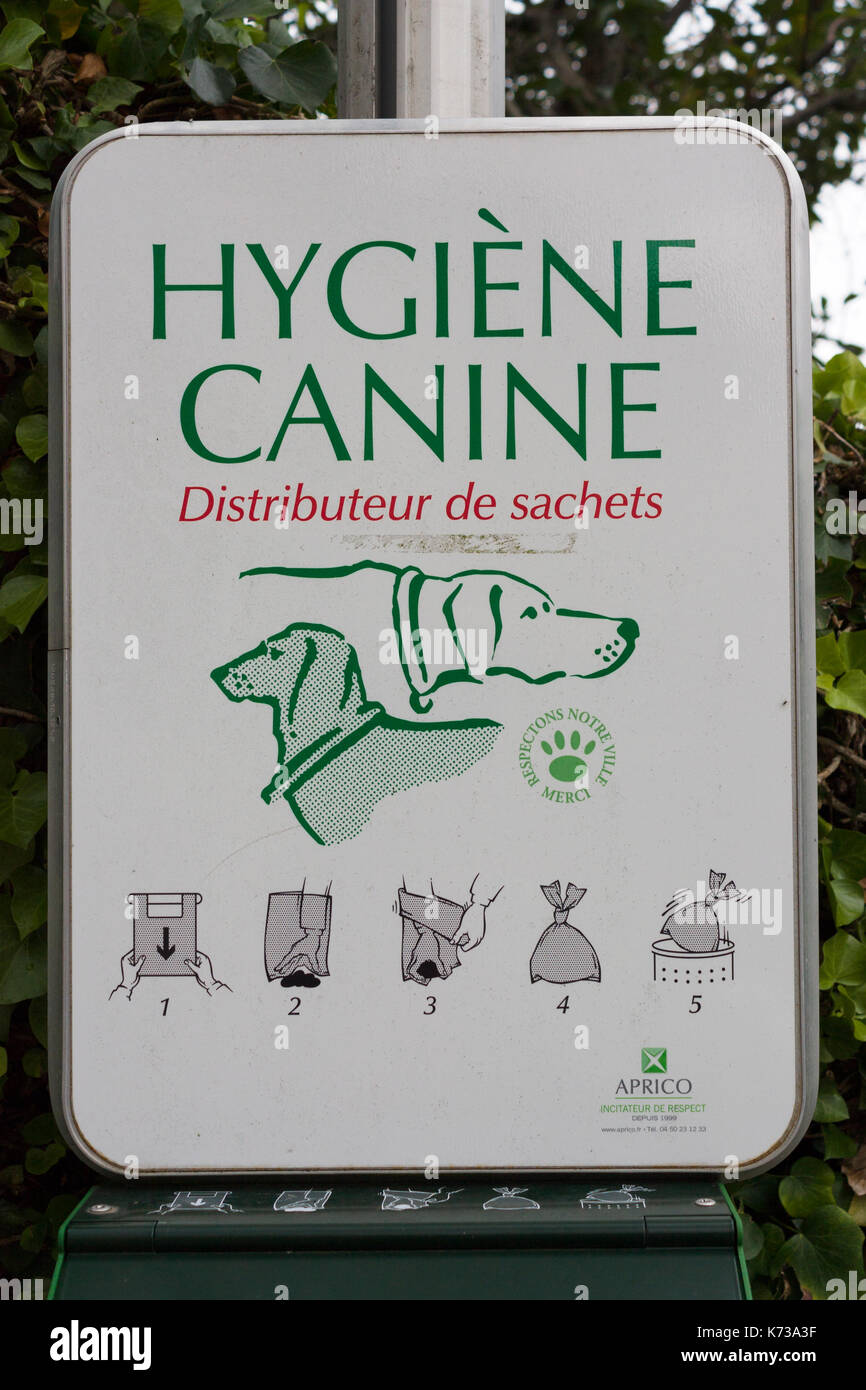 Sign at French dog waste bag distributor Stock Photo