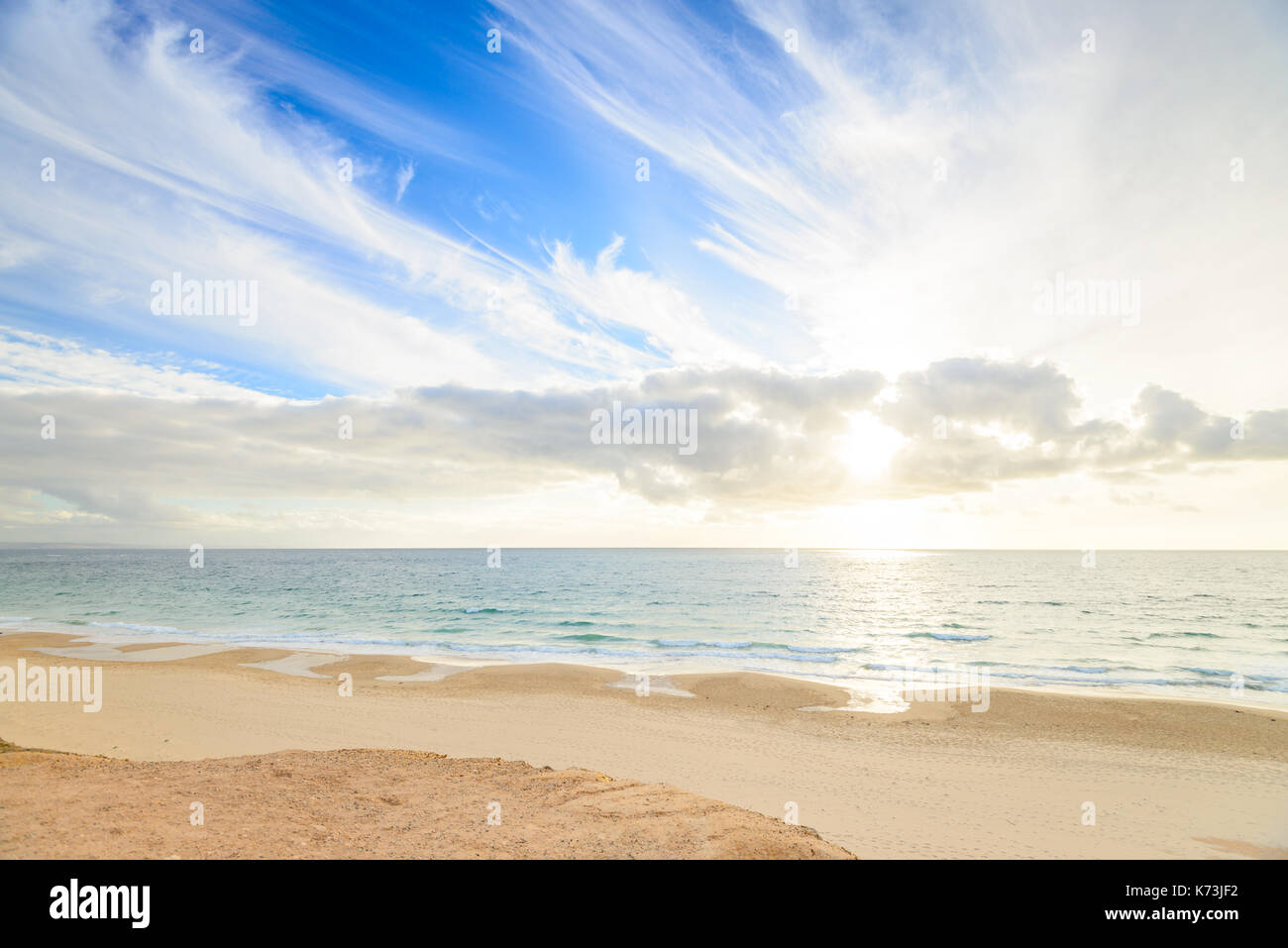 O'Sullivans Beach shoreline with clouds over sea at sunset, South