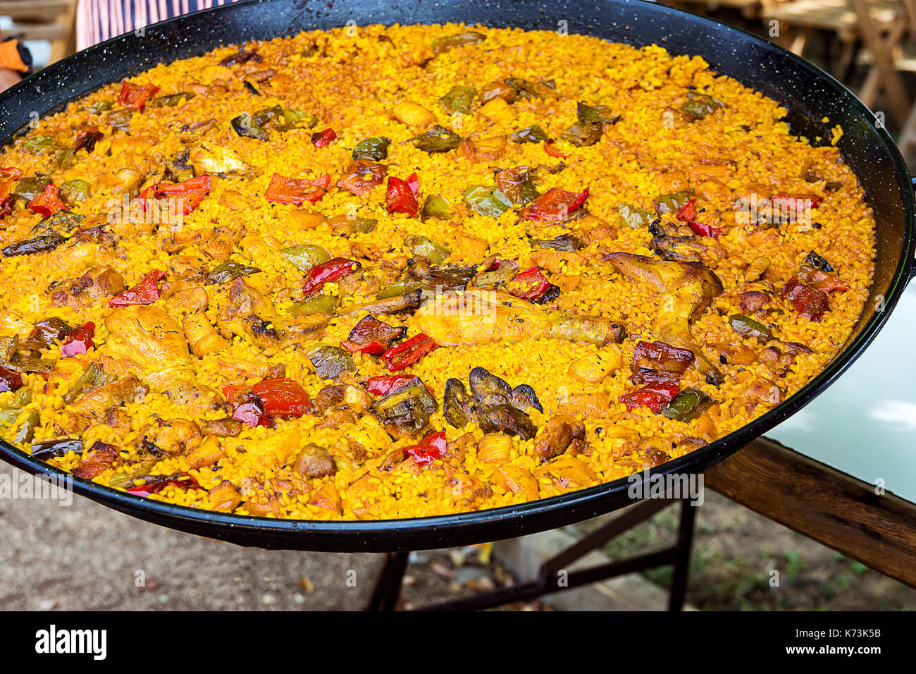 Large flat frying pan with cooked homemade Spanish paella with variety