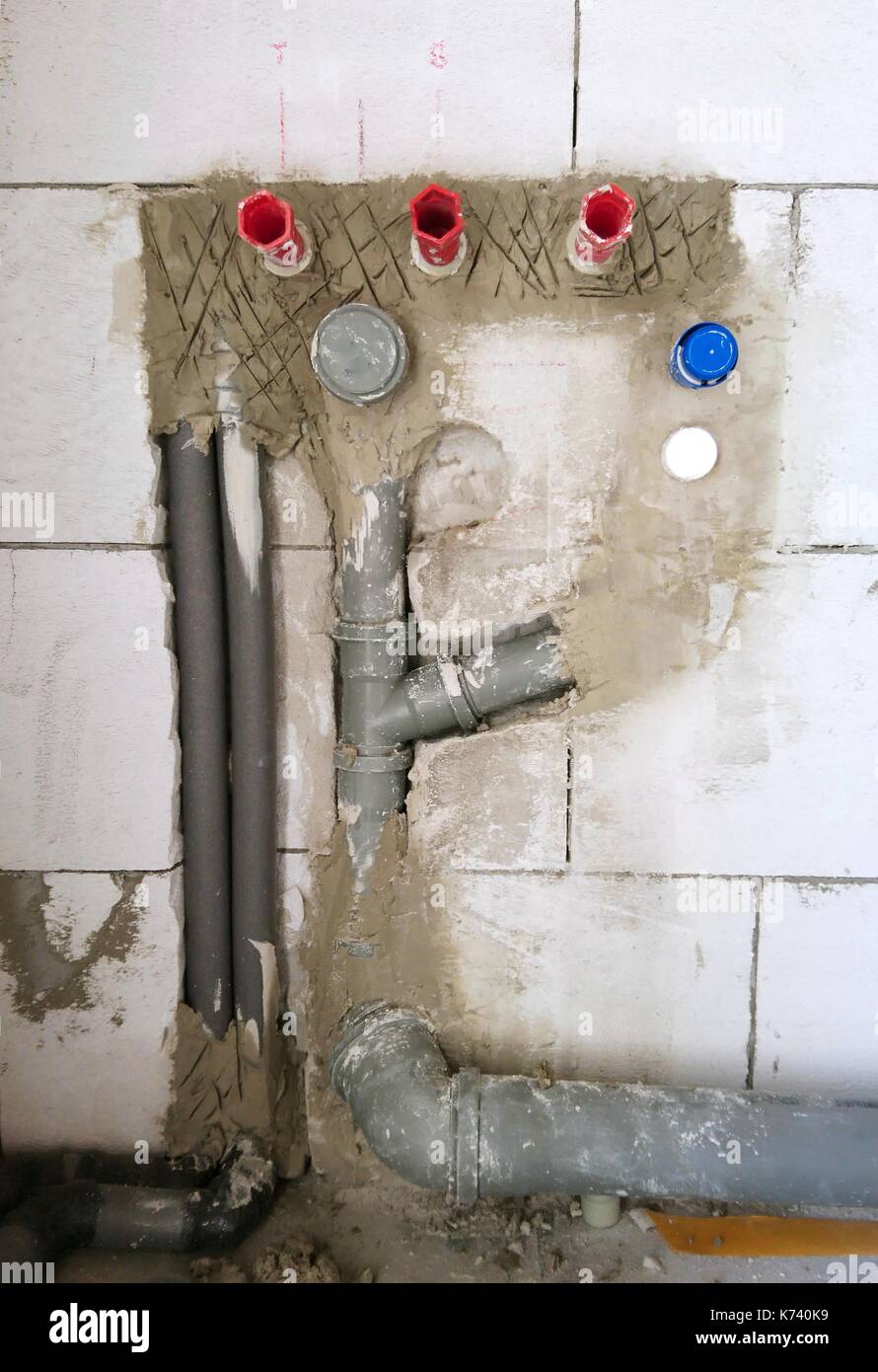 Installation of a water pipes and drainage tubes in new house construction. New water piping installation. Stock Photo