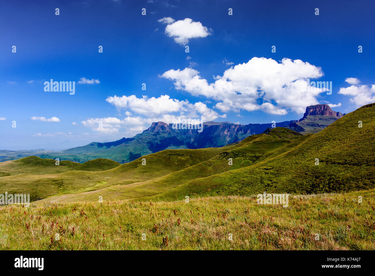 Color outdoor image of the mountain called Monks Cowl, Drakensberg, South Africa, taken in early morning on a sunny day in golden light with clear sky Stock Photo