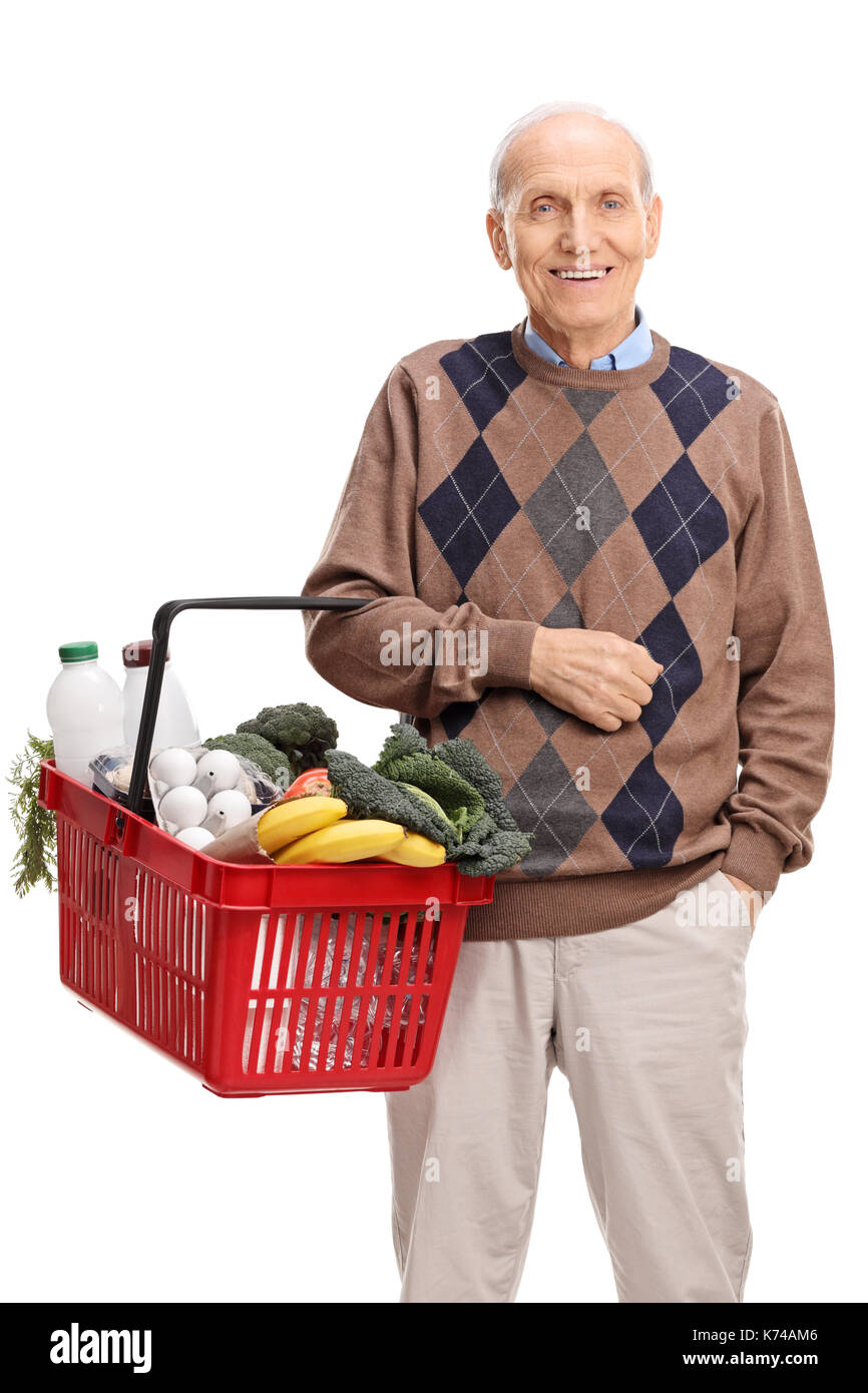 Elderly man holding a shopping basket filled with groceries isolated on white background Stock Photo