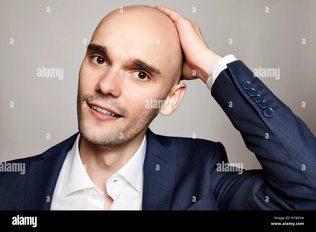 Men hand on head smile hi-res stock photography and images - Alamy