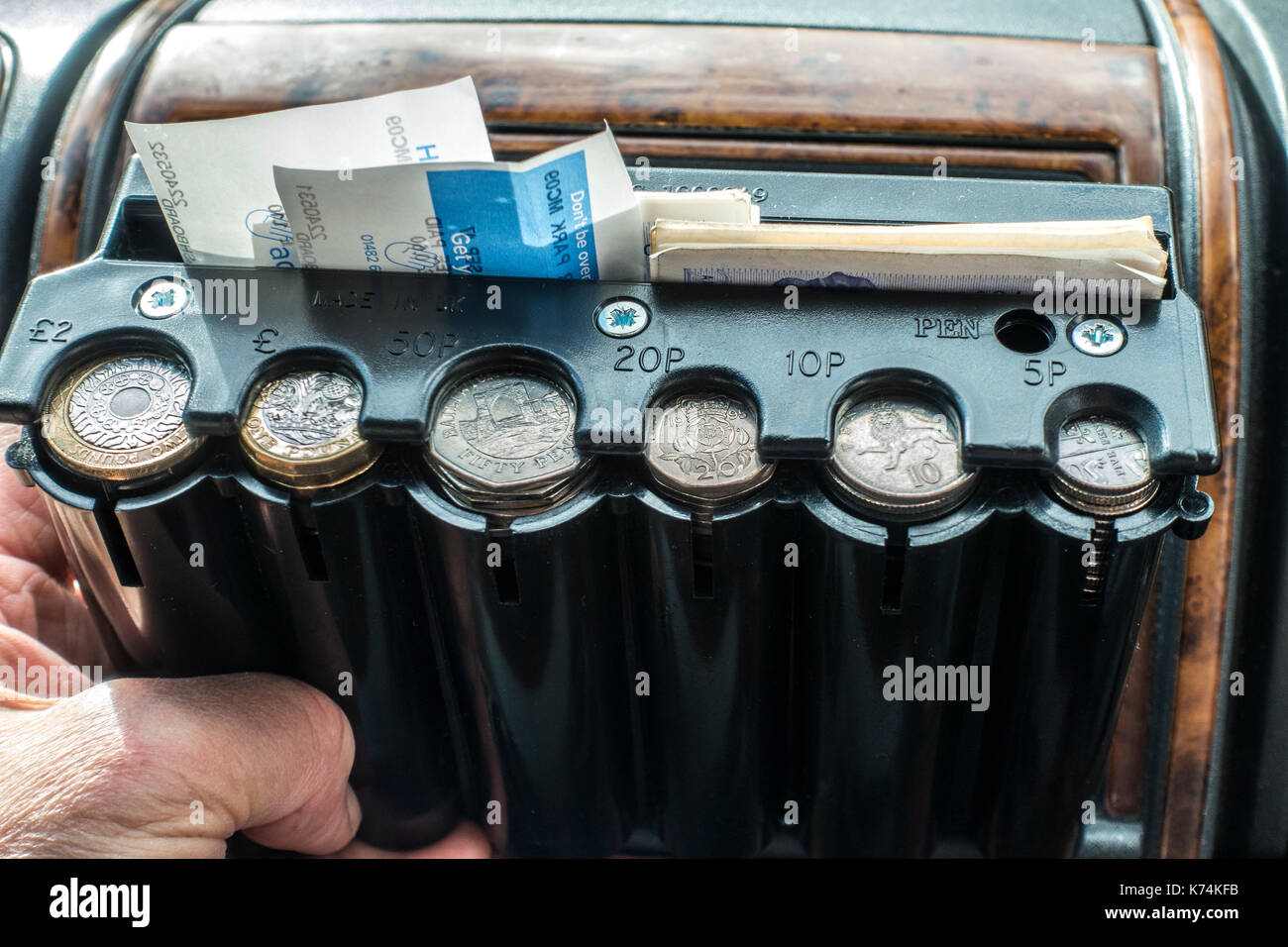 Plastic coin container for a taxi cab, for the various denominations of British money / UK sterling coins, as a ready supply of fare change. Stock Photo