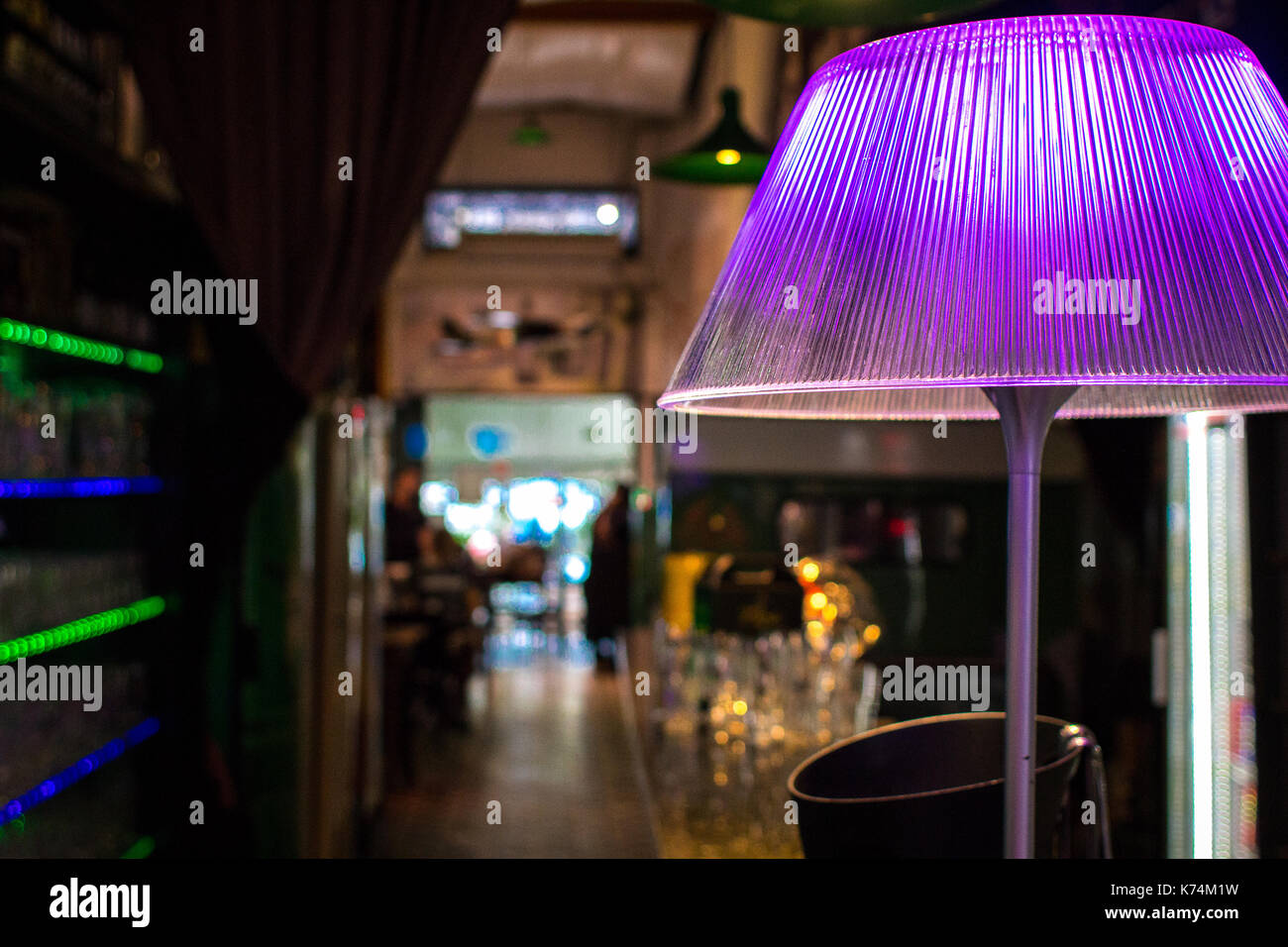 Lilac colored acrylic lampshade in the interior of a club as part of it´s fine decoration, beautiful color spreading in the room Stock Photo