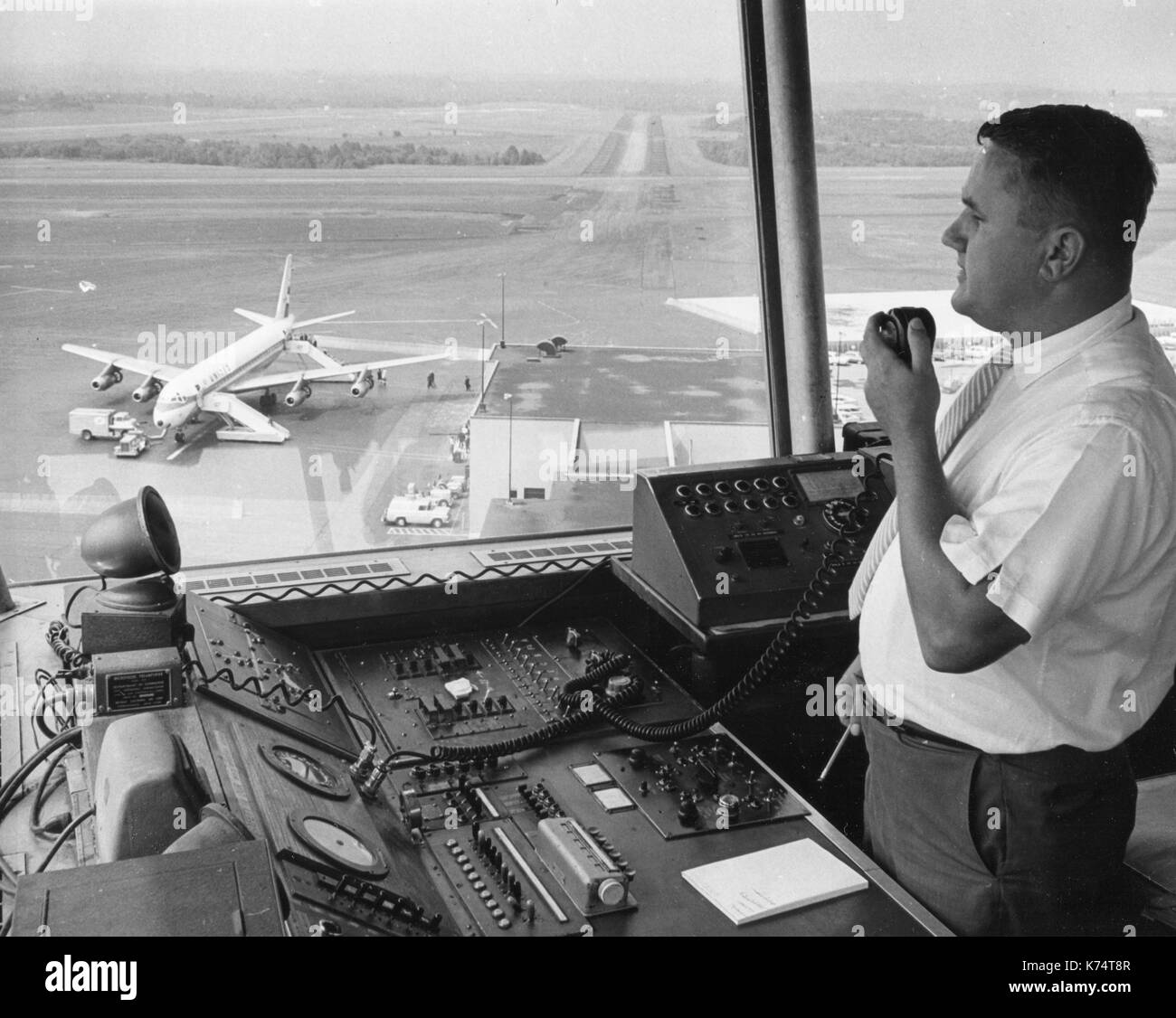 A Federal Aviation Agency (FAA) Air Traffic Controller guides a plane to a safe landing, 1965. Stock Photo