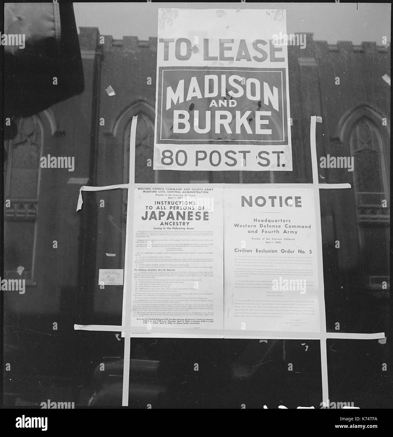Civilian Exclusion Order Number 5, ordering evacuation of residents of Japanese ancestry, posted in a vacant store window on Grant Avenue in Chinatown. San Francisco, CA, 4/4/1942. Photo by Dorothea Lange Stock Photo