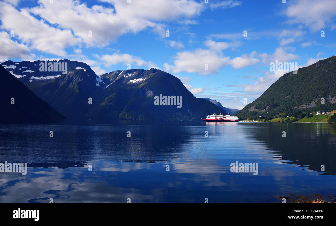 Hjorundfjord, Norway, September 2nd, 2017: Hurtigruten Cruise Ship in Fjord on a beautiful summer day Stock Photo