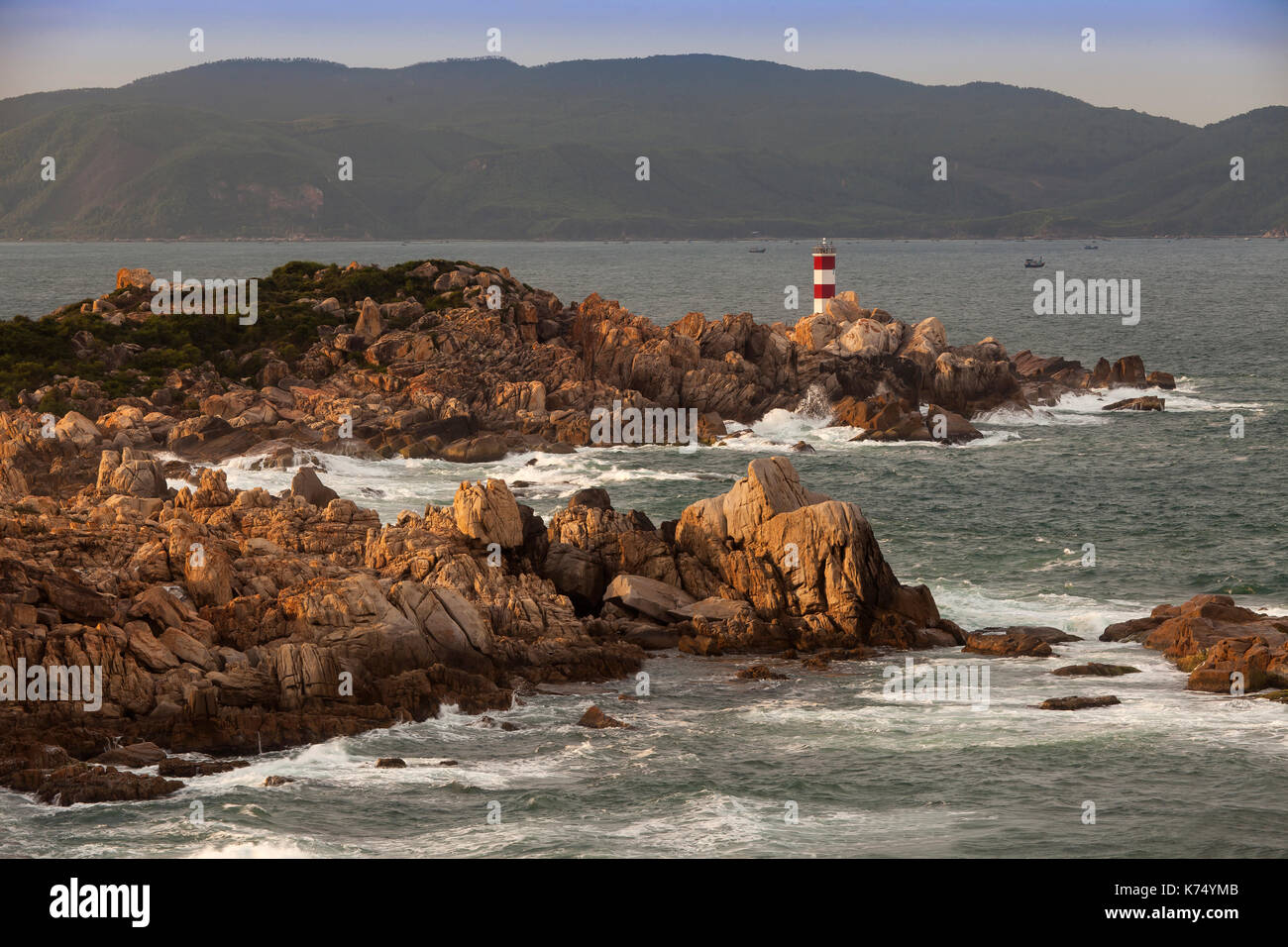 Rocky coast with lighthouse at Ganh Dia, Phu Yen Province, Vietnam Stock Photo