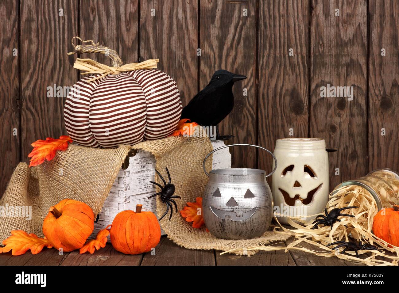 Rustic shabby chic Halloween decor against an aged wood background Stock Photo