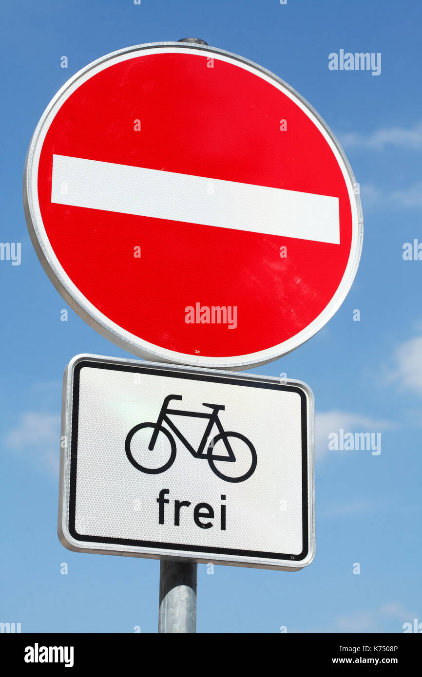 Traffic signs in front of blue sky, no entry, cyclists free, Germany Stock Photo