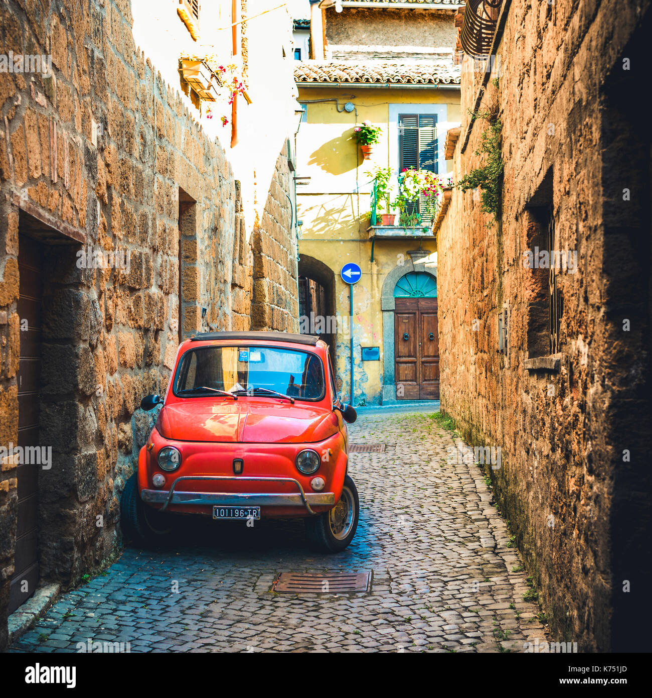 Old red Fiat 500 parked in a narrow alley, classic car, Orvieto, Umbria ...