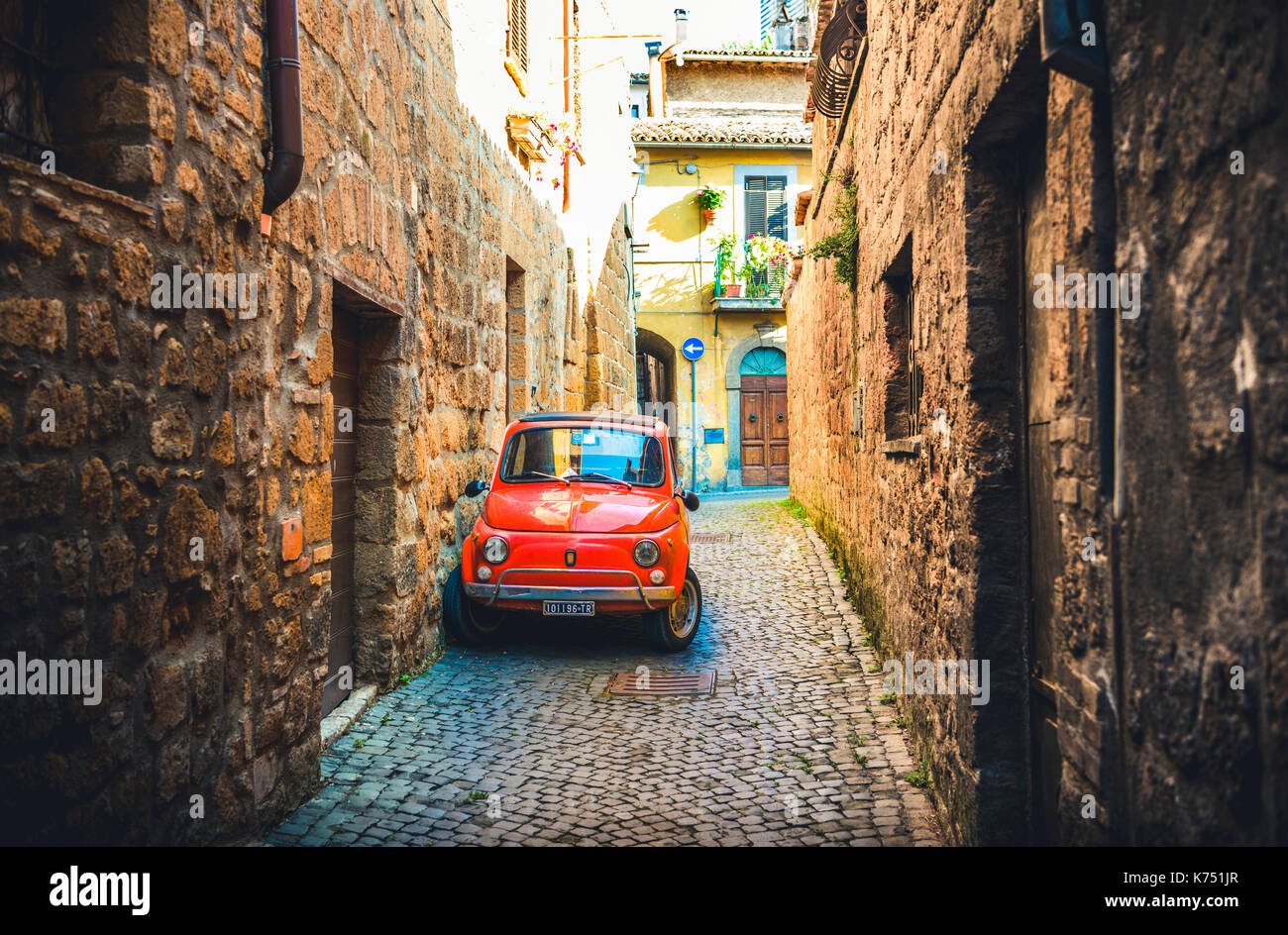 Old red Fiat 500 parked in a narrow alley, classic car, Orvieto, Umbria, Italy Stock Photo