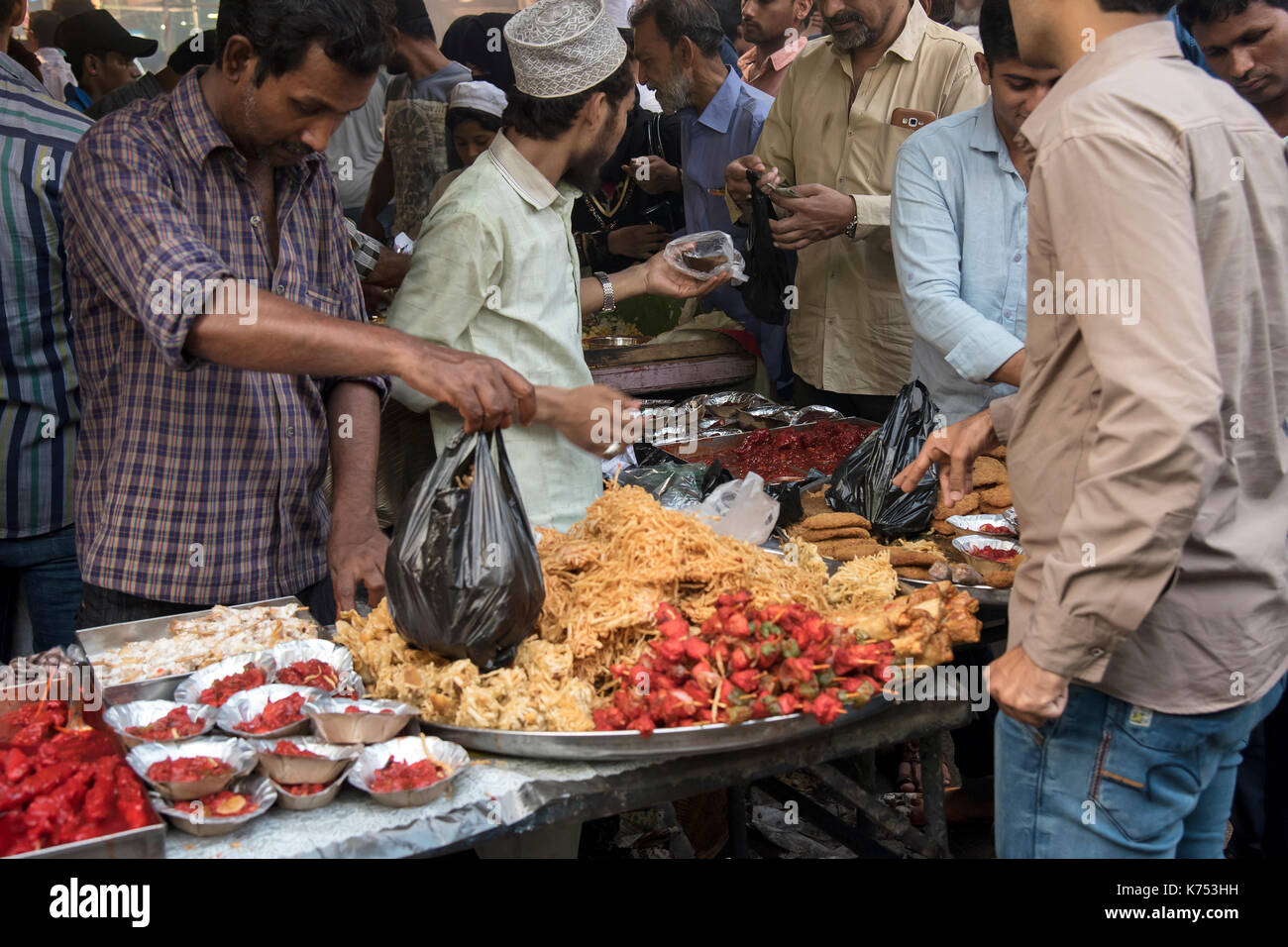The image of a food vendor selling eatables as Muslims break their Ramzan or Ramadan fasting at Miinara Masjid in Pydhonie ; Bombay Mumbai Stock Photo