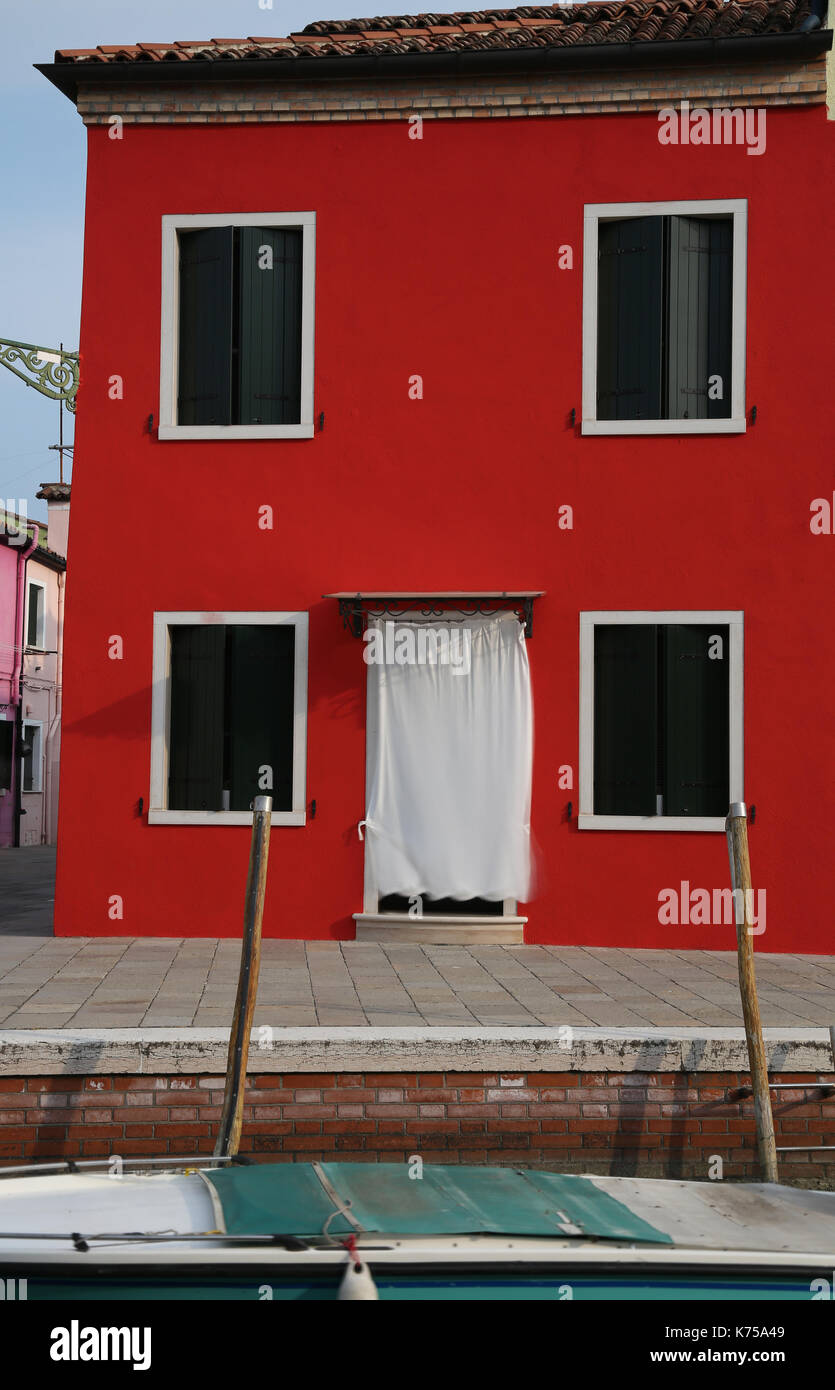 red house on the island of Burano near VENICE in northern Italy Stock Photo