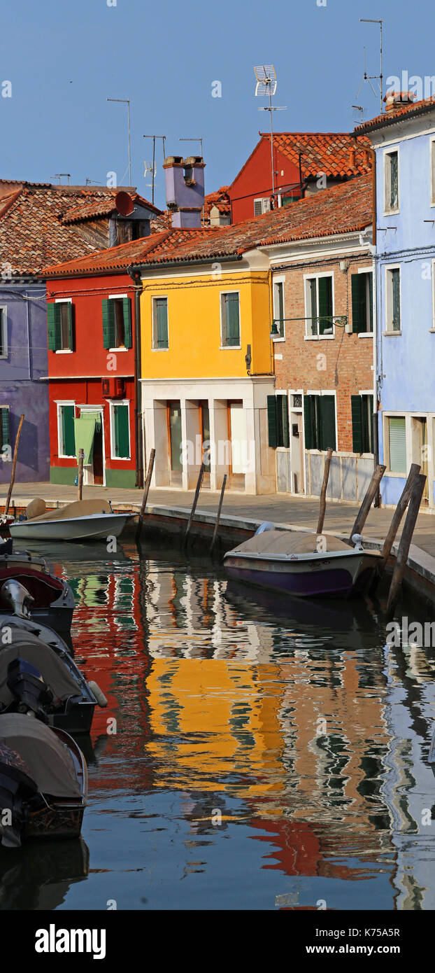 vivid colored houses and reflection on the water in the island of Burano in Venice in northern Italy Stock Photo