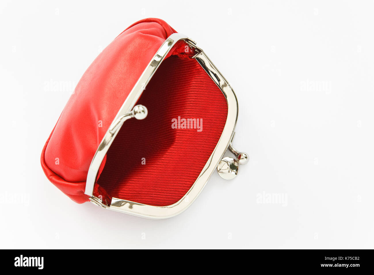 Empty purse open to illustrate poverty and austerity concept. Isolated on a plain white background. England, UK, Britain Stock Photo
