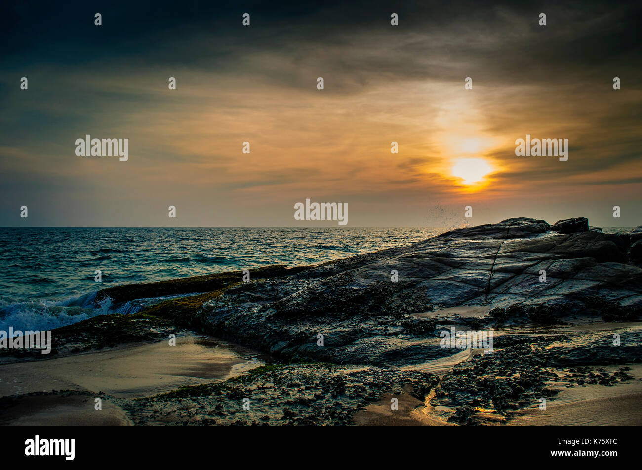 Sunset on a beach Stock Photo - Alamy