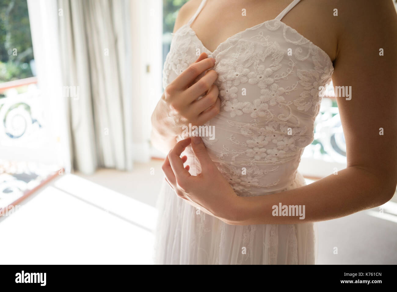 Young woman trying on wedding dress hires stock photography and images