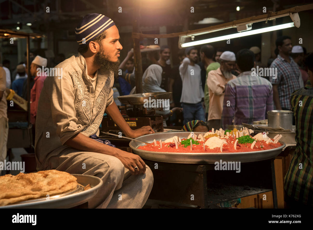 The image of a food vendor selling eatables as Muslims break their Ramzan or Ramadan fasting at Miinara Masjid in Pydhonie ; Bombay Mumbai Stock Photo