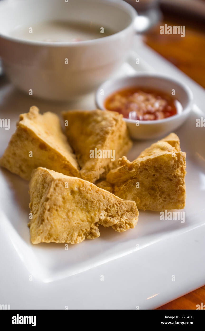 Thai deep fried tofu with peanut chili duck sauce for dipping Stock