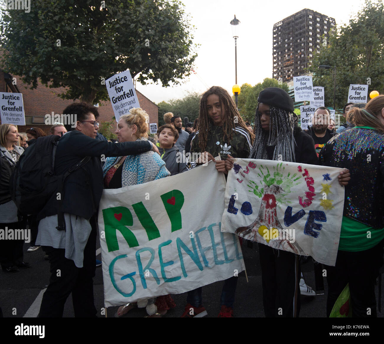 People take part in a silent march for Grenfell Tower fire victims in west London. Stock Photo