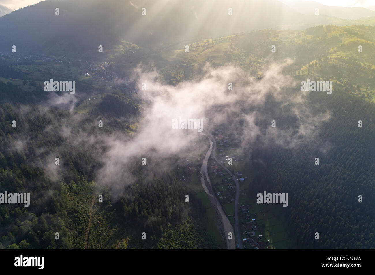 Aerial view of the village in the Carpathian mountains with clouds in ...