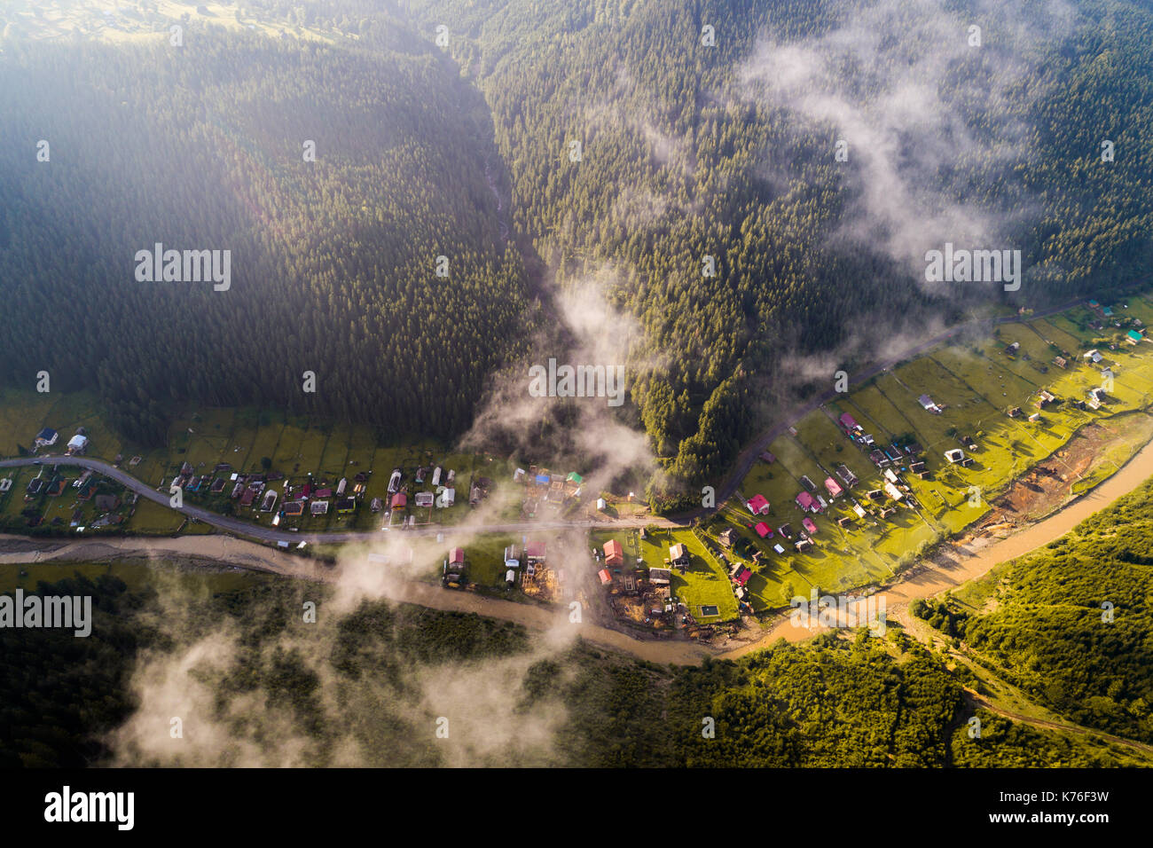Aerial view of the village in the Carpathian mountains with clouds in ...