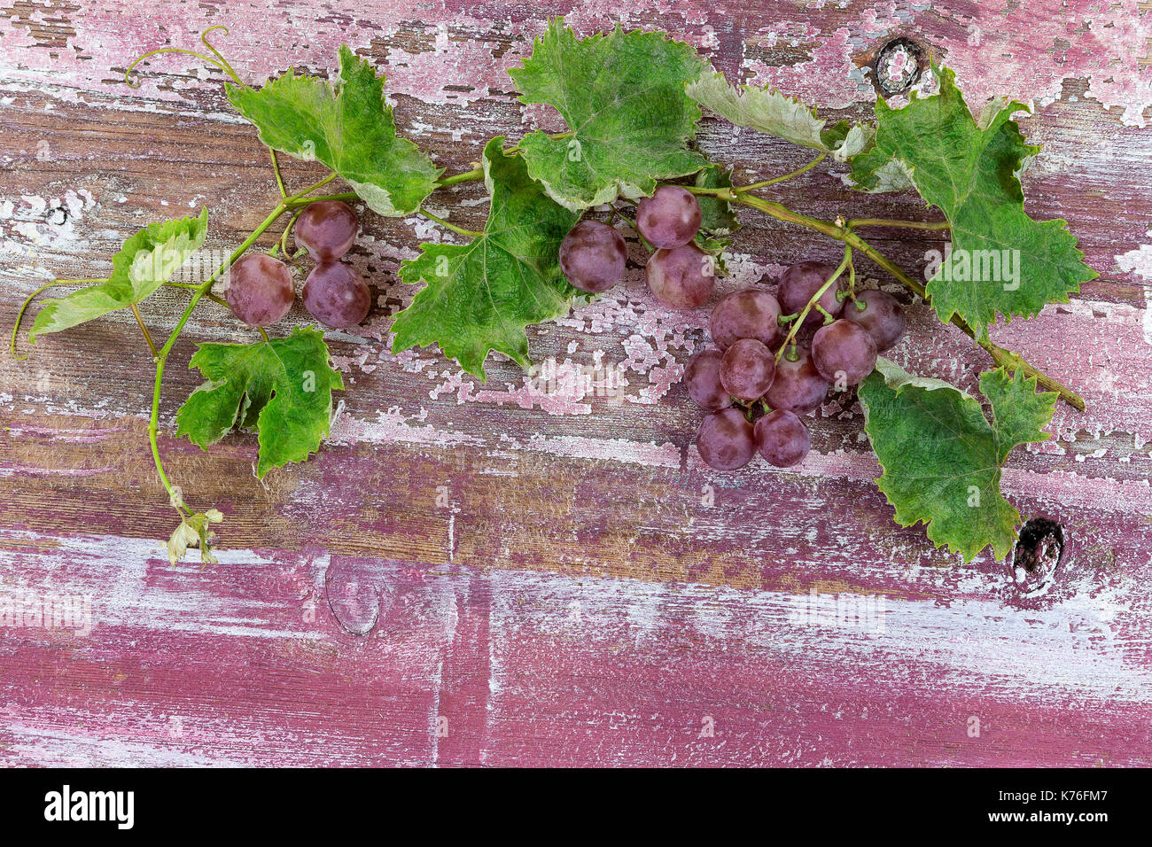 Bunch of red grapes on old purple paint wooden table Stock Photo