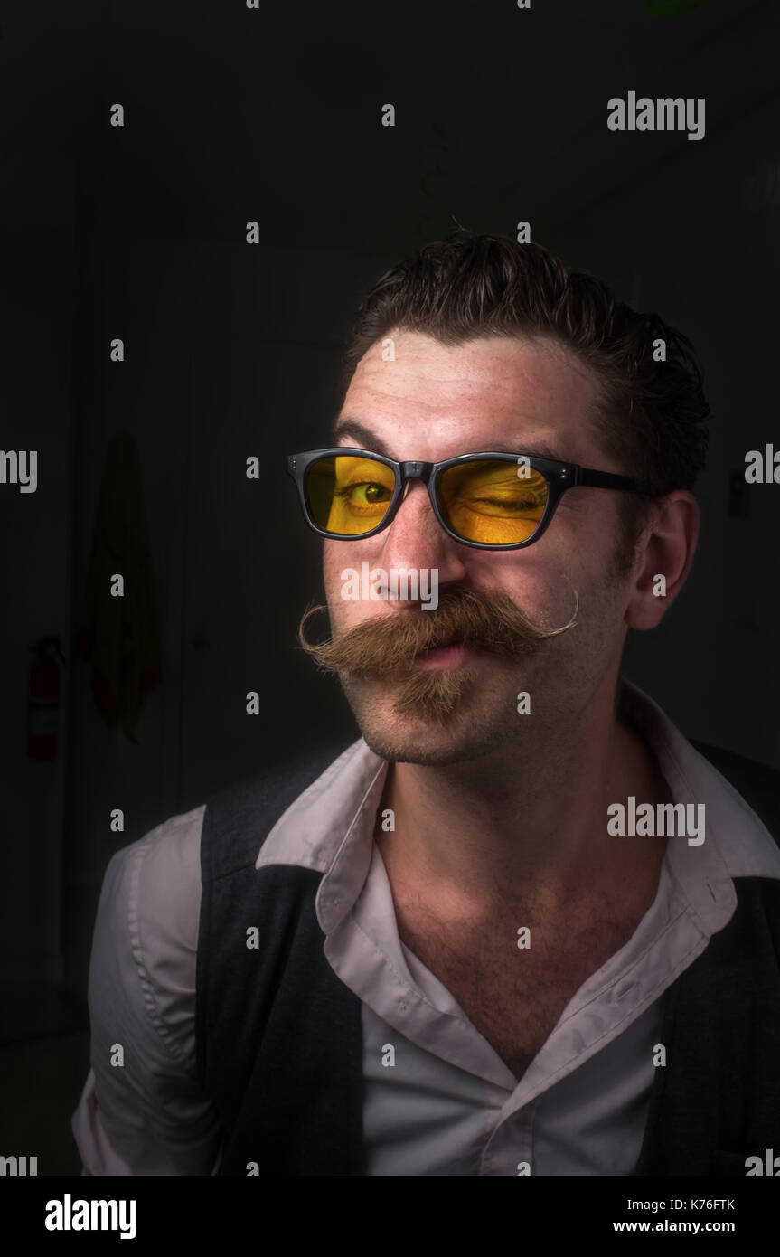 Caucasian hipster man with large handlebar mustache wearing a dress