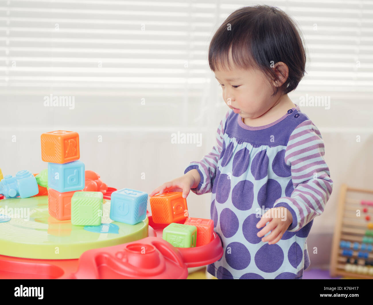 baby girl playing toy at home Stock Photo - Alamy