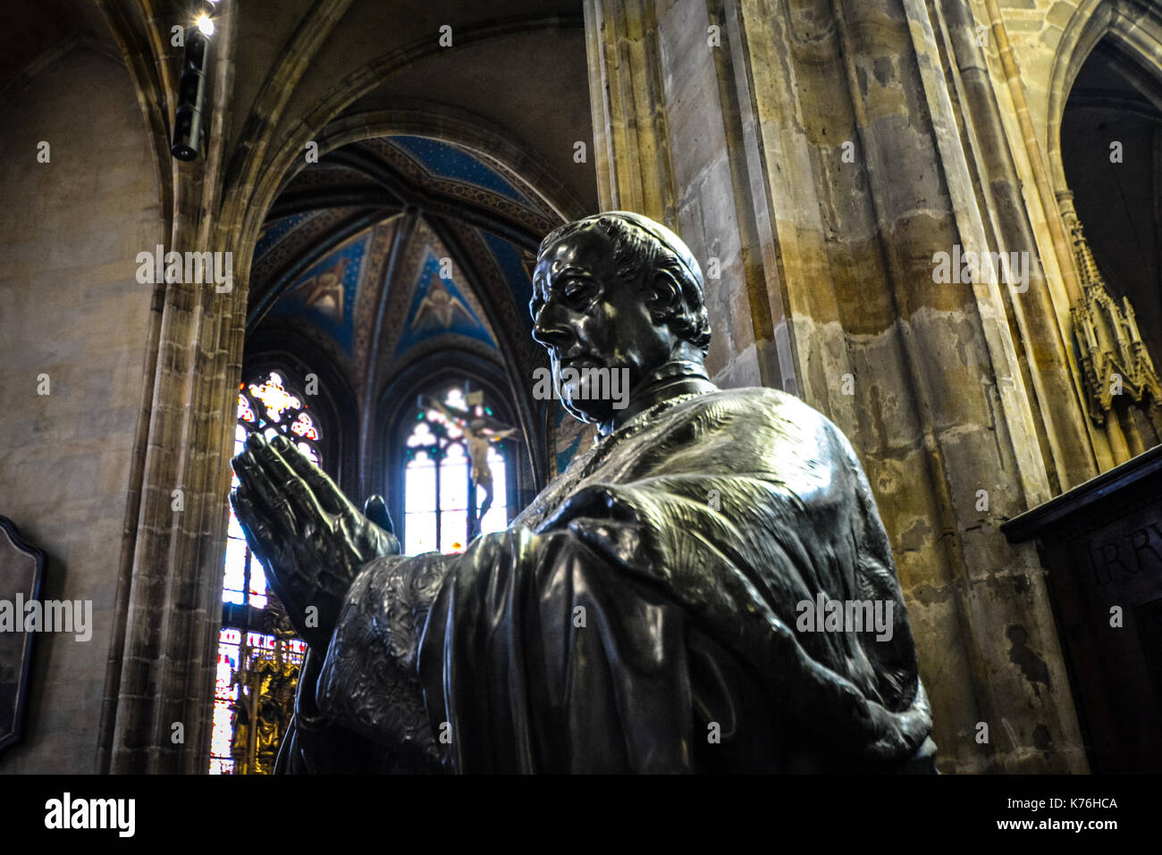 Bronze statue of a religious figure (Saint or pope) praying inside the