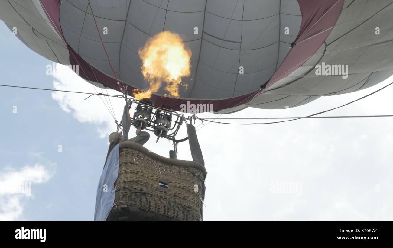 Close up of a hot air balloon flying in the sky. Flying-up balloon with ...