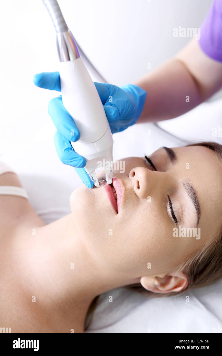 A vacuum facial massage using a special head. Woman in the clinic of