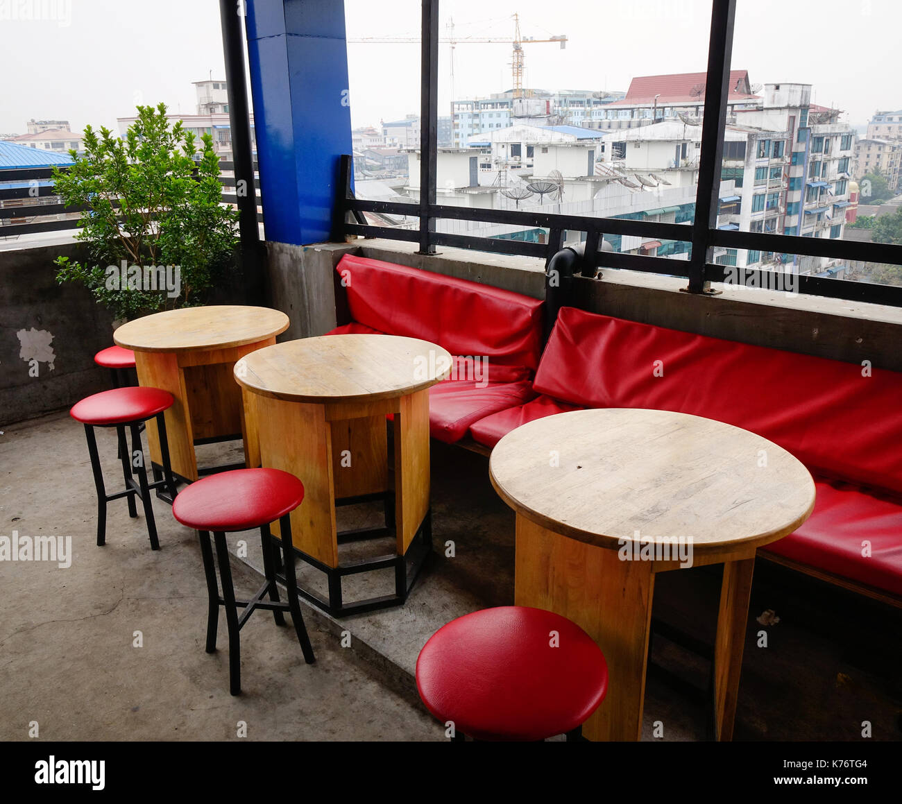Chairs and tables at coffee shop with city view in Yangon, Myanmar