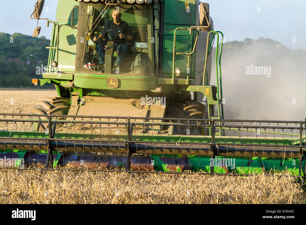 Close up of the cab and header of a combine harvester while in operation, Nottinghamshire, England, UK Stock Photo