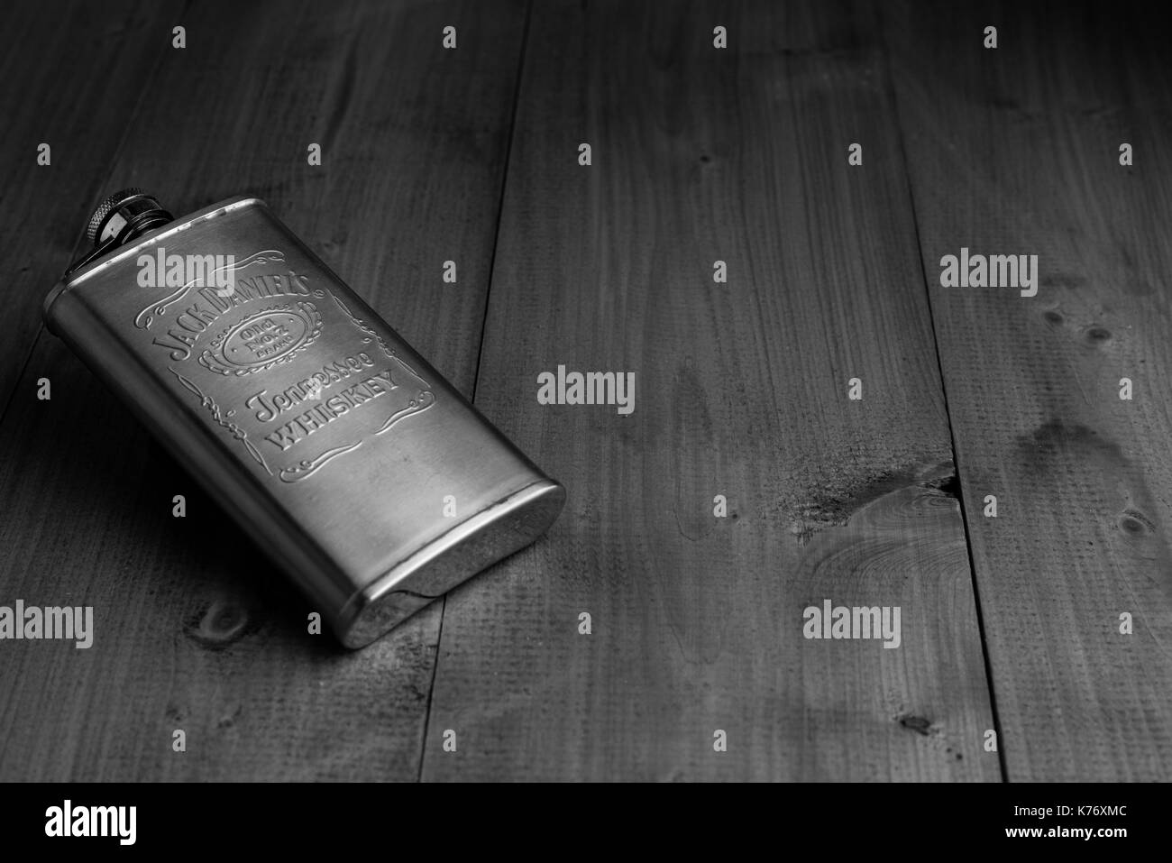 Jack Daniels Hip Flask on wooden surface. Stock Photo