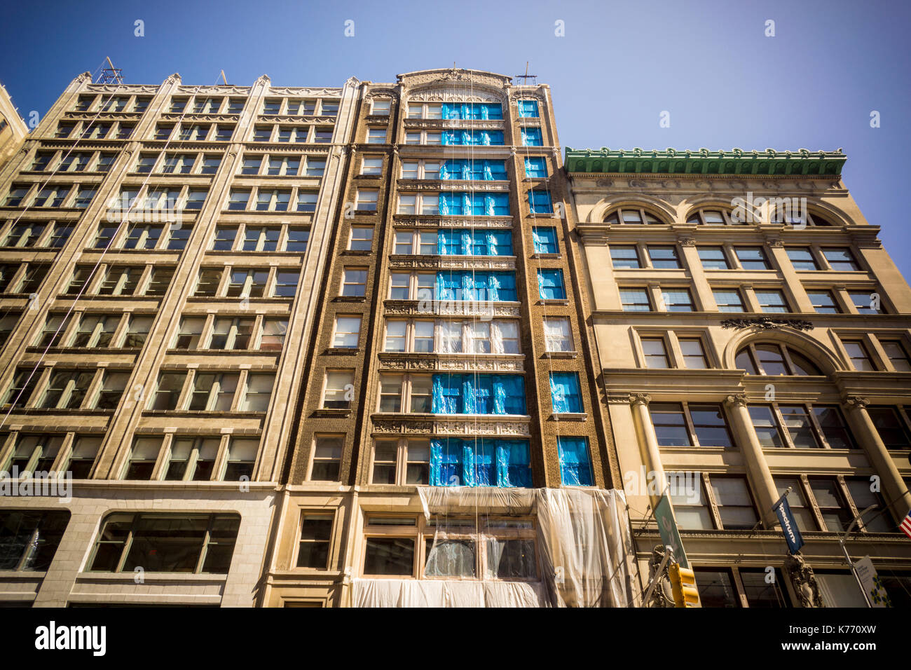 A building in chelsea in New York undergoes restoration of its facade