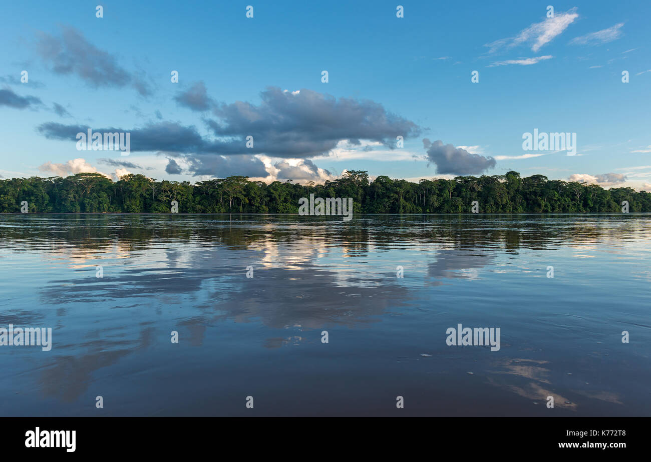 Landscape of the Pastaza River in the Amazon river basin with a cloud reflection and the rainforest tree canopy, Ecuador. Stock Photo
