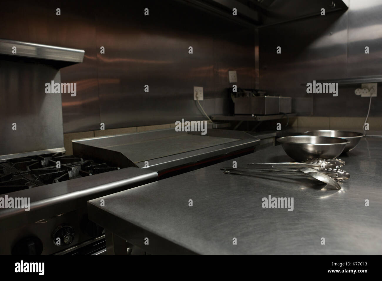 Various utensils on worktop in commercial kitchen Stock Photo