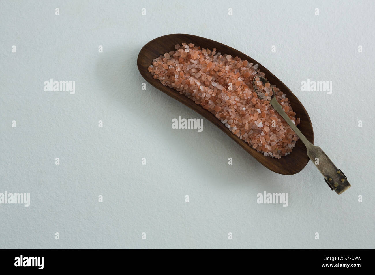 Sea salt in tray on white background Stock Photo - Alamy